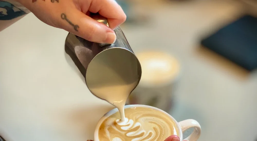 Cafe wren pouring foam